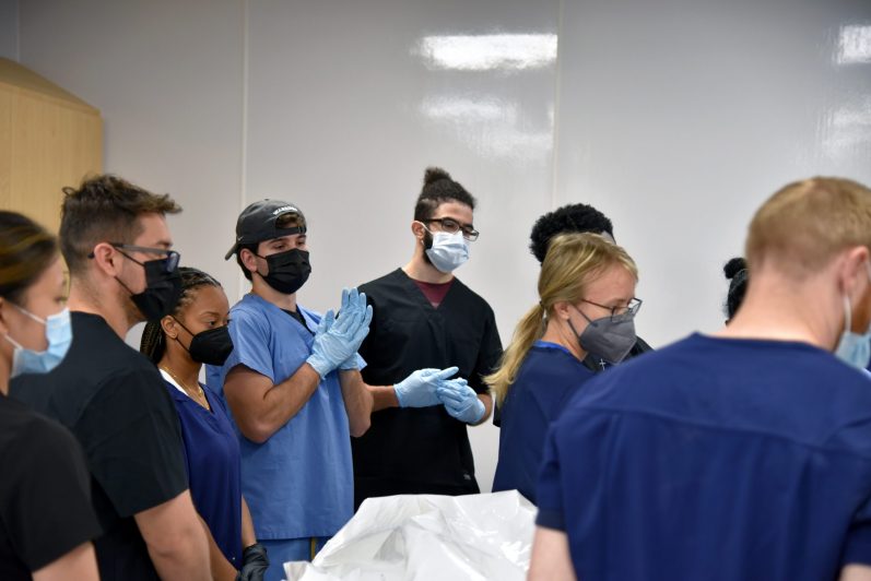 A group of students in an anatomy lab being instructed.