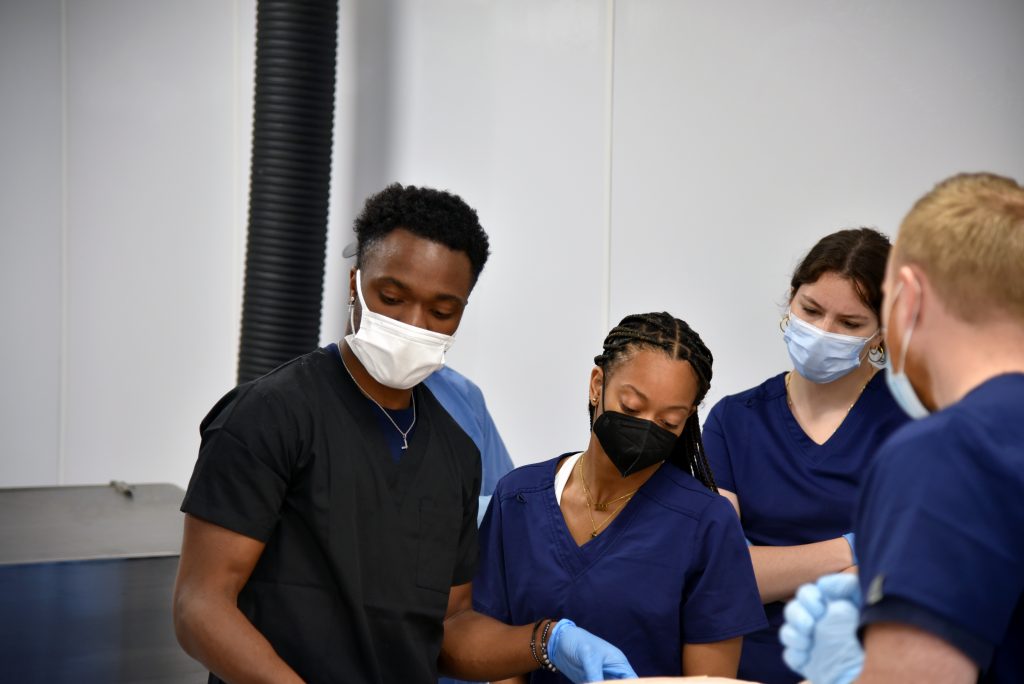 A group of four students in the UConn anatomy lab. 