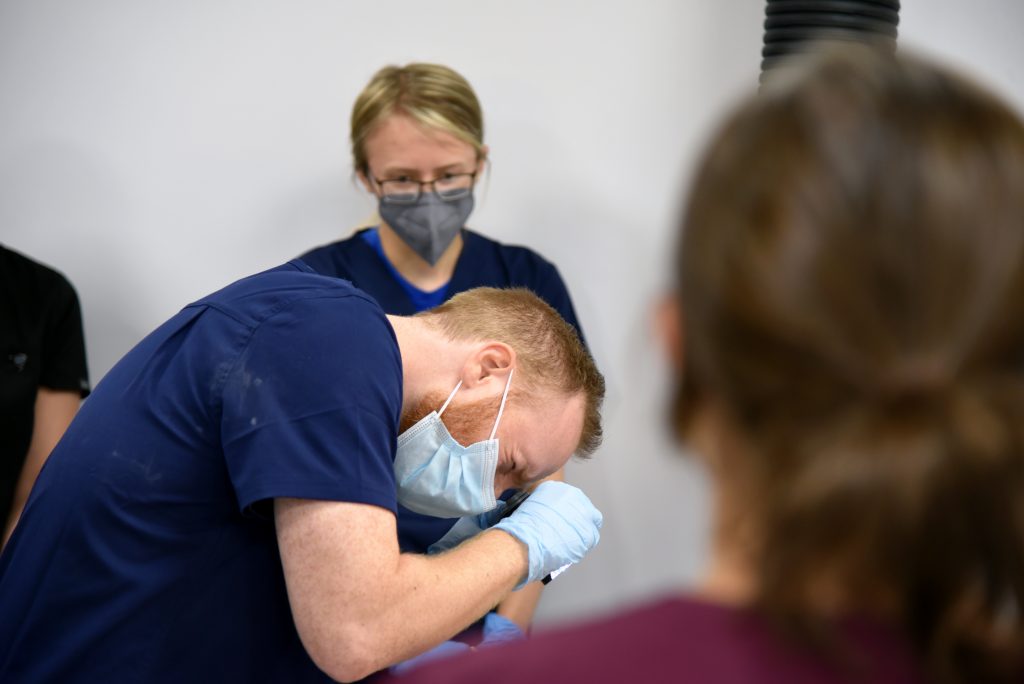 A student participating in anatomy lab.