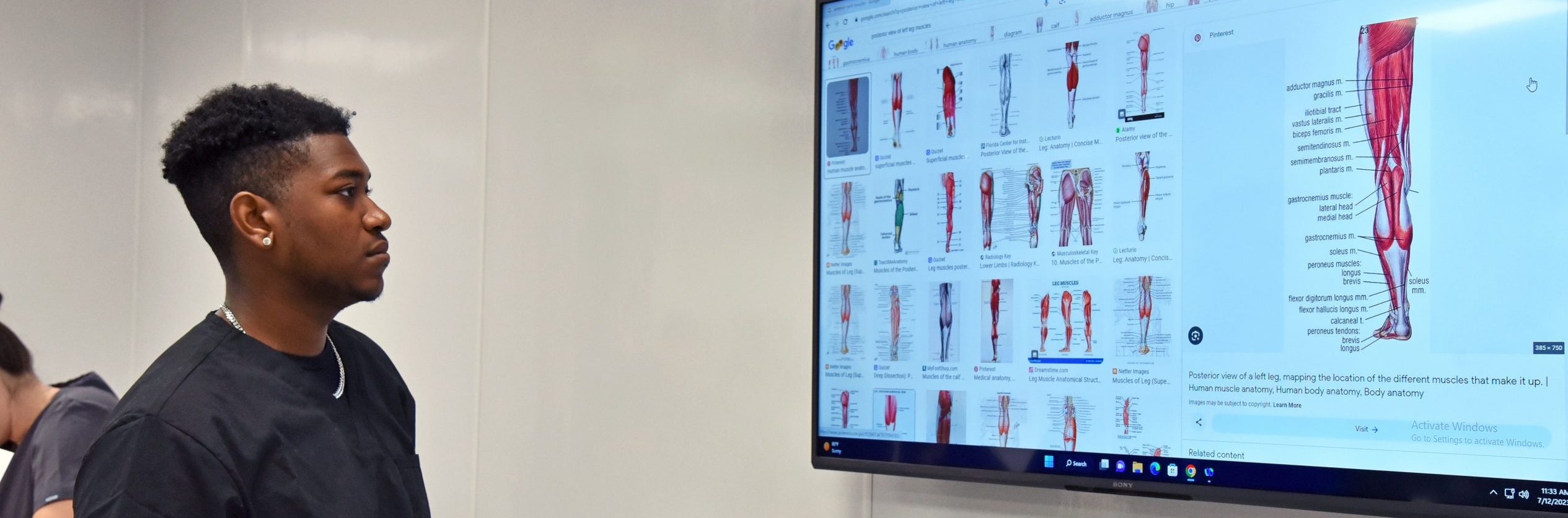 Hero Image of a student viewing a SMART board image of leg anatomy.